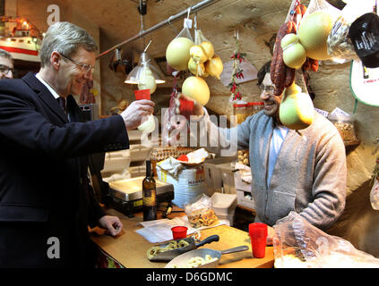 German President Christian Wulff visits a delicatessen shop and try specialties in Bari, Italy, 15 February 2012. The German President and his wife are on a three-day visit to Italy. Photo: WOLFGANG KUMM Stock Photo