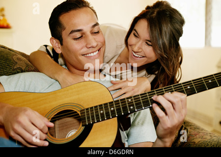 Man playing guitar for girlfriend Stock Photo