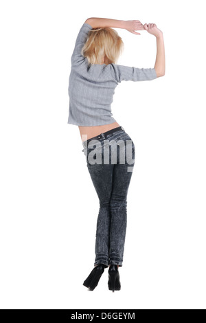 Young woman dancing. Rear view. Stock Photo