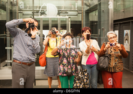 Tourists taking pictures in museum Stock Photo