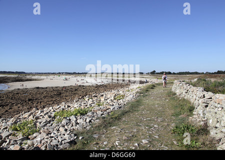 Walker on the coastal path near Locmariaquer under a beautiful blue sky, Brittany, France, Sept 2012 Stock Photo