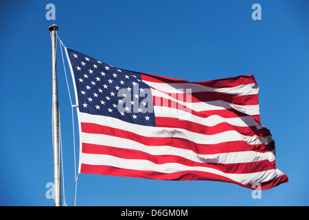 American flag waving in light blue sky with white clouds Stock Photo ...