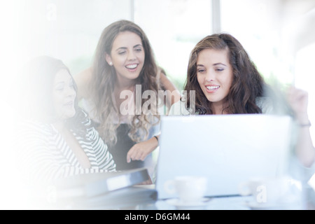 Businesswomen using laptop at desk Stock Photo
