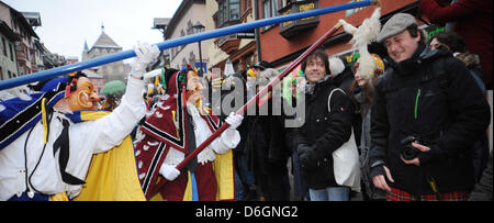 So-called Federahannes, a fools character from Rottweil, jump through the air during the traditional fools jump ('Narrensprung') in Rottweil, Germany, 20 February 2012. The fools jump is one of the most traditional parades of the Swabian-Alemannic carnival. Photo: PATRICK SEEEGR Stock Photo