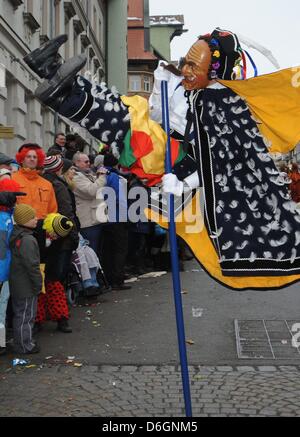 A so-called Federahannes, a fools character from Rottweil, jumps through the air during the traditional fools jump ('Narrensprung') in Rottweil, Germany, 20 February 2012. The fools jump is one of the most traditional parades of the Swabian-Alemannic carnival. Photo: PATRICK SEEEGR Stock Photo