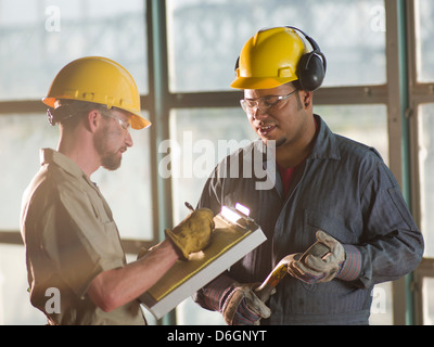 Engineers talking on construction site Stock Photo