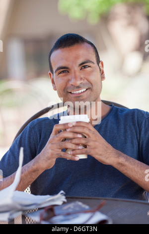Man having cup of coffee outdoors Stock Photo