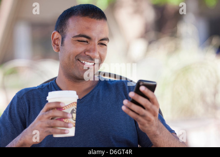 Man having cup of coffee outdoors Stock Photo