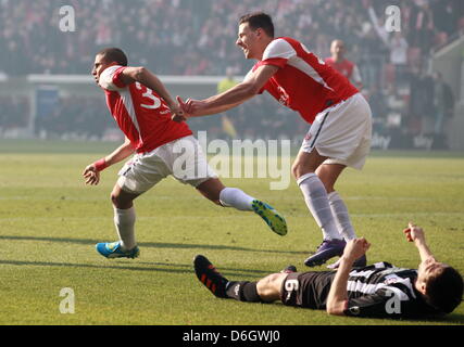 Mainz's Mohamed Zidan (L) celebrates his 1-0 goal with Adam Szalai (R) next to Kaiserslautern's Mathias Abel (bottom) during the German Bundesliga match between 1. FSV Mainz 05 and 1. FC Kaiserslautern at the Coface Arena in Mainz, Germany, 25 February 2012. Photo: ROLAND HOLSCHNEIDER  (ATTENTION: EMBARGO CONDITIONS! The DFL permits the further utilisation of the pictures in IPTV,  Stock Photo