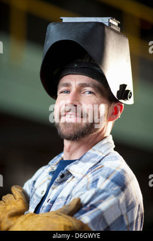 Industrial worker smiling in plant Stock Photo