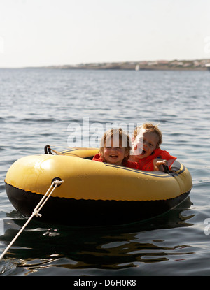 Children riding in inflatable boat Stock Photo