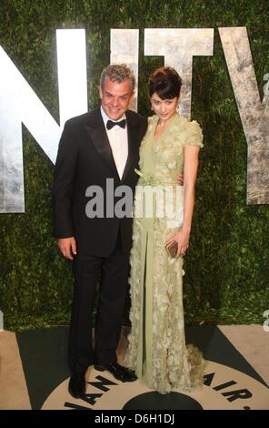 Ukrainian actress Olga Kurylenko and director Danny Huston attend the 2012 Vanity Fair Oscar Party at Sunset Tower in Los Angeles, USA, 26 Februar 2012. Photo: Hubert Boesl Stock Photo