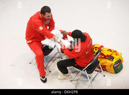Ukrainian WBO, IBF, WBA and IBO heavyweight boxing world champion Wladimir Klitschko has his bandages put on by his US American coach Emanuel Steward greets the fans before a public training session in a car dealership in Duesseldorf, Germany, 29 February 2012. W. Klitschko will fight Mormeck on 03 MArch 2012. Photo: ROLF VENNENBERND Stock Photo
