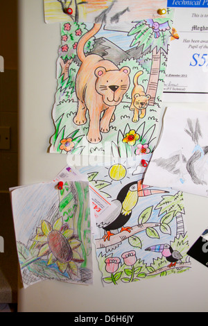 Kids drawings on fridge door Stock Photo