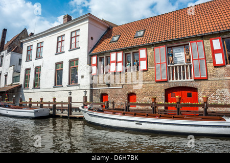 Canal and tourist boat in Bruges, Belgium Stock Photo