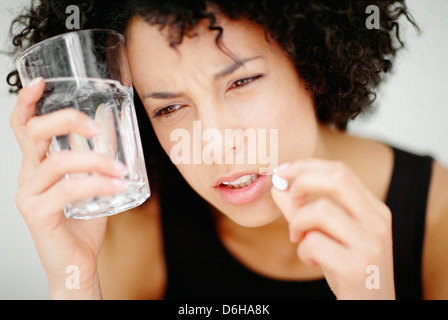 Woman taking a pill Stock Photo
