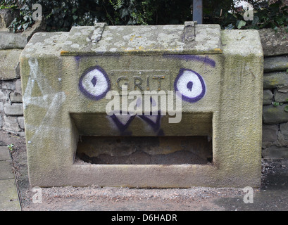 Grit bin with graffiti face painted on Stock Photo