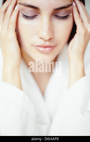 Woman massaging her temples Stock Photo