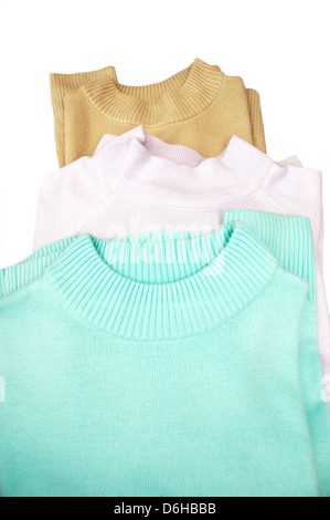 Pile of ladies turtle necked jumpers / sweaters / tops isolated on a white background Stock Photo