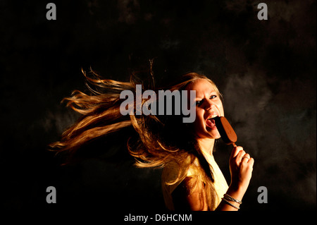 A young woman with a chocolate magnum ice cream Stock Photo