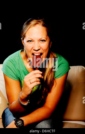 A young woman with a chocolate magnum ice cream Stock Photo