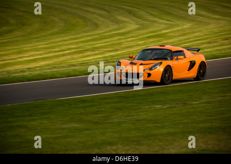 Orange Series 2 Lotus Exige car on the track at Cadwell Park. Stock Photo