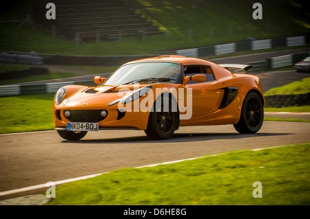 Orange Series 2 Lotus Exige car on the track at Cadwell Park. Stock Photo