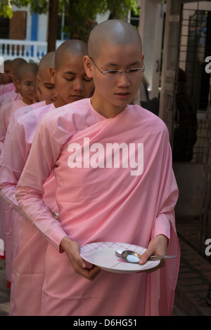 Nuns queuing for a meal, Sakyadhita Thilashin Nunnery School, Sagaing, near Mandalay, Myanmar, (Burma) Stock Photo