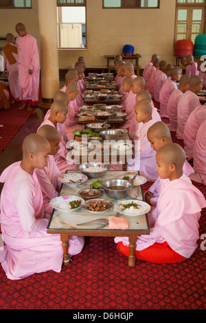 Nuns eating their meals, Sakyadhita Thilashin Nunnery School, Sagaing, near Mandalay, Myanmar, (Burma) Stock Photo