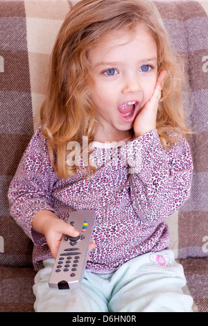 Cute little girl watching TV at night Stock Photo - Alamy
