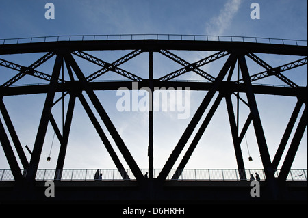 Pedestrians Walking on Newly Opened Big Four Bridge Silhouetted against Blue Sky in Louisville, Kentucky Stock Photo