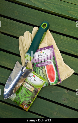 Burpee Organic and Heirloom Seed Packets with Garden Gloves and Hand Trowel Stock Photo