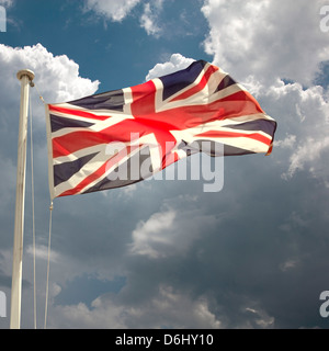 British flag on flagpole set against cloudy sky. brexit concept Stock Photo