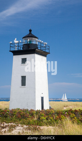 Two masted schooner sails by Long Point Lighthouse, Cape Cod, on a clear summer day Stock Photo