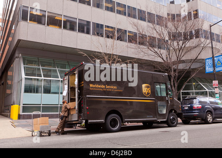 UPS man unloading packages from delivery truck - Washington, DC USA Stock Photo
