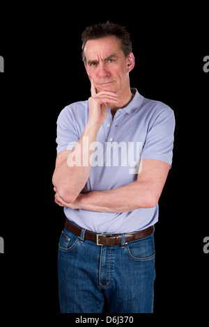 Confused Frowning Middle Age Man Hand to Chin Black Background Stock Photo