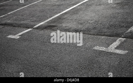 Empty parking places on dark asphalt with white lines Stock Photo