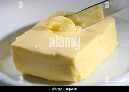 FILE - A file photo dated 09 July 2008 shows a knife and a piece of butter in Duesseldorf, Germany. The prizes of butter are decreasing to 89 cents per piece. Photo: David Ebener Stock Photo