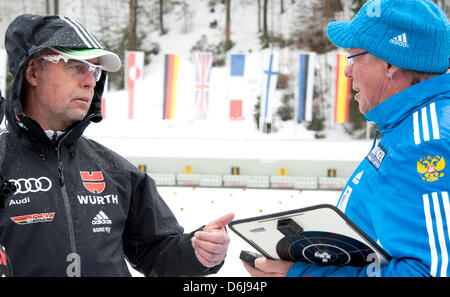 Head coach of the German team Uwe Muessiggang (L) talks to the Russian women's coach, the Austrian Wolfgang Pichler during the women's training session of the biathlon world championships at the Chiemgau Arena in Ruhpolding, Germany, 08 March 2012. Photo: PETER KNEFFEL Stock Photo