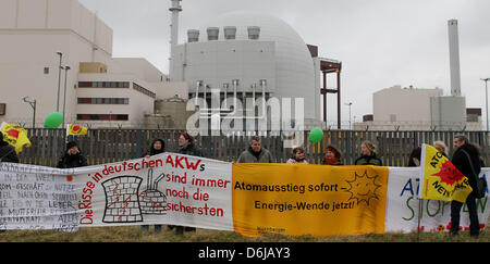 People demonstrate against nuclear energy with banners in front of the nuclear power plant Brokdorf, Germany, 11 March 2012. One year after the catastrophy at Japan's nuclear power plant Fukushima, about 3000 demonstrators protested against nuclear energy. Photo: Malte Christians Stock Photo