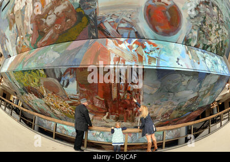 Painter Sighard Gille stands with his daughter Maja and granddaughter at his ceiling painting 'Gesang vom Leben' in Gewandhaus in Leipzig, Germany, 25 February 2012. The painting was created on the sloping ceiling of the foyer between 1980 and 1981 and is 714 square meters large and 31.80 meters high. The restoration of water damage to the painting caused renovations to the roof in Stock Photo