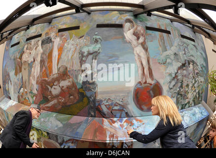 Painter Sighard Gille stands with his daughter Maja at his ceiling painting 'Gesang vom Leben' in Gewandhaus in Leipzig, Germany, 25 February 2012. The painting was created on the sloping ceiling of the foyer between 1980 and 1981 and is 714 square meters large and 31.80 meters high. The restoration of water damage to the painting caused renovations to the roof in 2009 and the resu Stock Photo