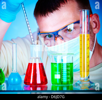 Young scientist in laboratory with test tubes Stock Photo
