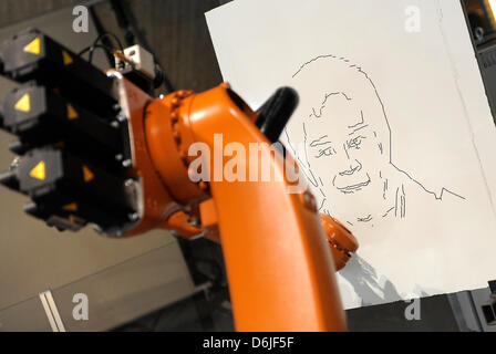 A robots draws a picture at Phaeno Science Center in Wolfsburg, Germany, 16 March 2012. A robot festival will take place at Phaeno with robots from all over the world. Photo: DOMINIQUE LEPPIN Stock Photo