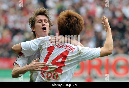 Augsburg's Ja-Cheol Koo (front) celebrates his 1-1 goal with Paul Verhaegh (L) during the German Bundesliga soccer match between FC Augsburg and 1.FSV Mainz 05 at the SGL Arena in Augsburg, Germany, 17 March 2012. Photo: STEFAN PUCHNER     (ATTENTION: EMBARGO CONDITIONS! The DFL permits the further  utilisation of the pictures in IPTV, mobile services and other new  technologies on Stock Photo