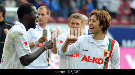 Augsburg's  Gibril Sankoh and Hajime Hosogai (R) celebrate after the German Bundesliga soccer match between FC Augsburg and 1.FSV Mainz 05 at the SGL Arena in Augsburg, Germany, 17 March 2012. Augsburg won 2-1. Photo: STEFAN PUCHNER     (ATTENTION: EMBARGO CONDITIONS! The DFL permits the further  utilisation of the pictures in IPTV, mobile services and other new  technologies only  Stock Photo