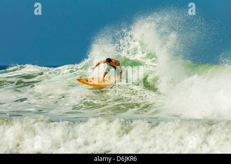 Surfer on shortboard riding wave at popular Playa Guiones surf beach, Nosara, Nicoya Peninsula, Guanacaste Province, Costa Rica Stock Photo