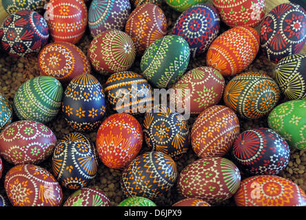 Colourfull eggs lie on a large plate at the 15th Sorbian Easter Egg Market in Schleife, Germany, 24 March 2012. The four techniques of designing Easter eggs - wax-batik, wax-embossment, scratching and etching - are presented to the public until 25 March 2012. Photo: Matthias Hiekel Stock Photo