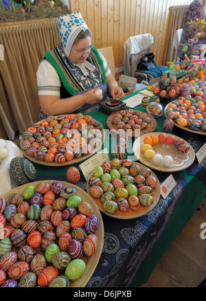 Kerstin Hanusch, wearing a Sorbian traditional costume, is one of 30 participants of the 15th Sorbian Easter Egg Market in Schleife, Germany, 24 March 2012. The four techniques of designing Easter eggs -  wa-batik, wax-embossment, scratching and etching - are presented to the public until 25 March 2012. Photo: MATTHIAS HIEKEL Stock Photo