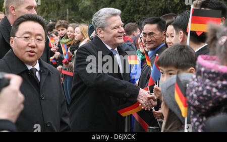 German President Joachim Gauck (C) receives President of Mongolia, Tsakhia Elbegdorj (L) at the Bellevue Palace and greets people from Mongolia living in Berlin, Germany, 29 March 2012. The President of Mongolia is on a state visit to Germany for several days. Photo: WOLFGANG KUMM Stock Photo